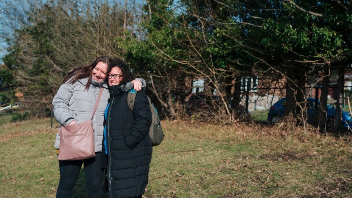 CAP client stood outside with her arm around her debt coach