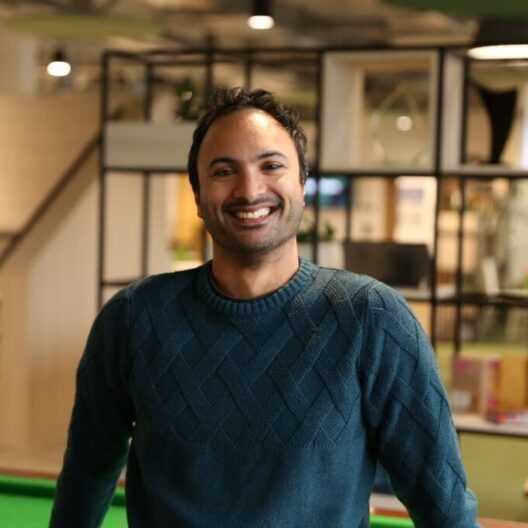 CAP staff member, Josh, stood in the Bradford support hub, smiling at the camera