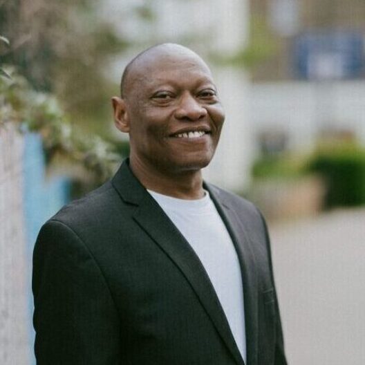 CAP client, Jim, not debt free, stood outside smiling at the camera