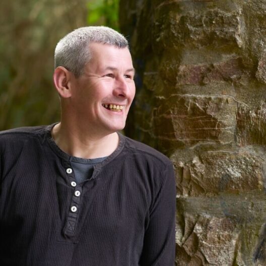 CAP client, Peter, stood outside, smiling away from the camera