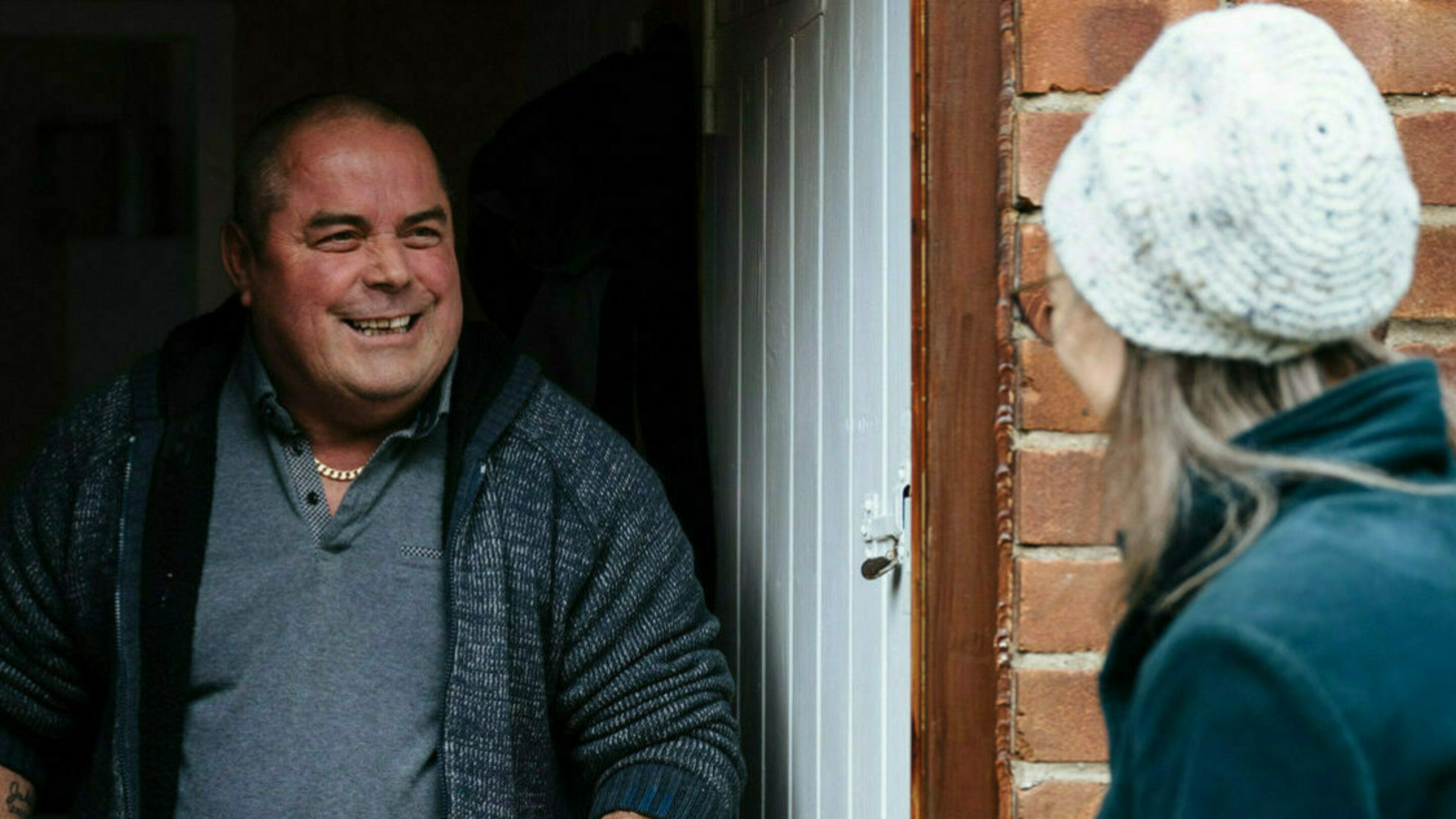 A smiling CAP client, meeting a volunteer on his door step