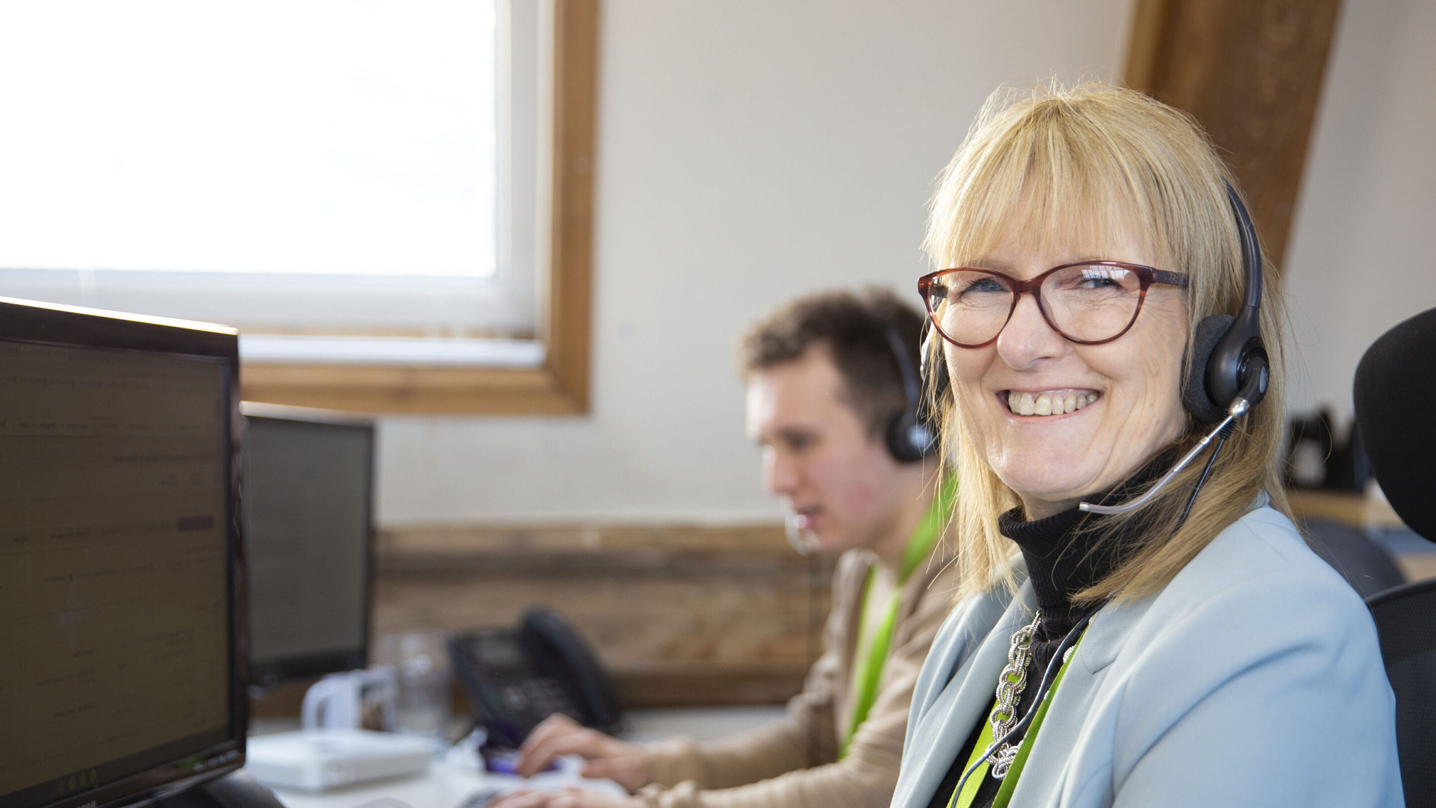 CAP worker on the phone to a supporter, smiling