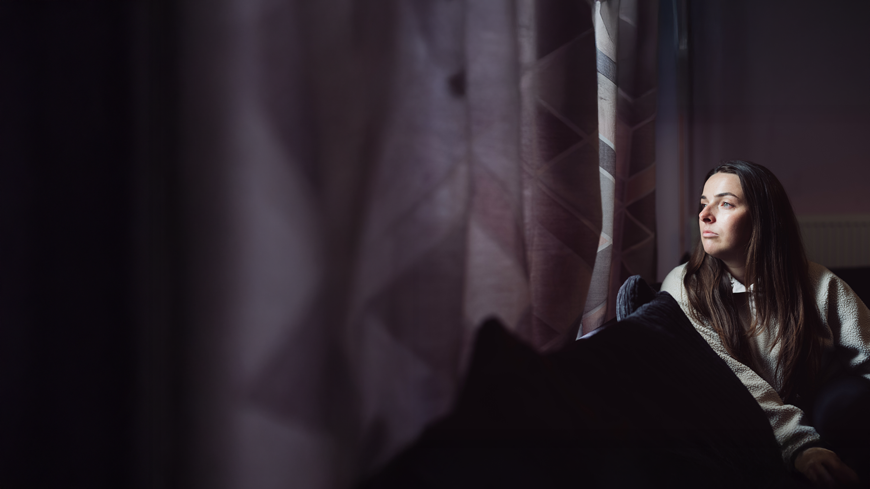 Jade, mum of three, looking out of the window.