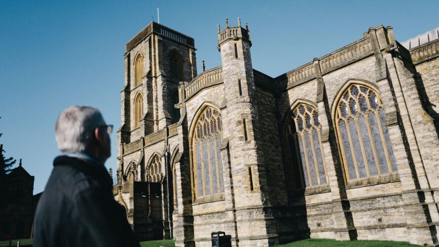 Retired debt coach, Steve, stood in cathedral grounds looking at the church