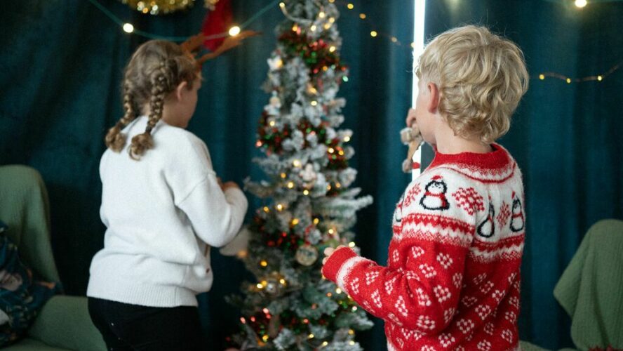 two children around a Christmas tree