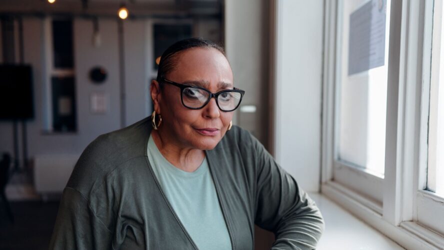 CAP client, Sharon, stood by a window, looking into the camera