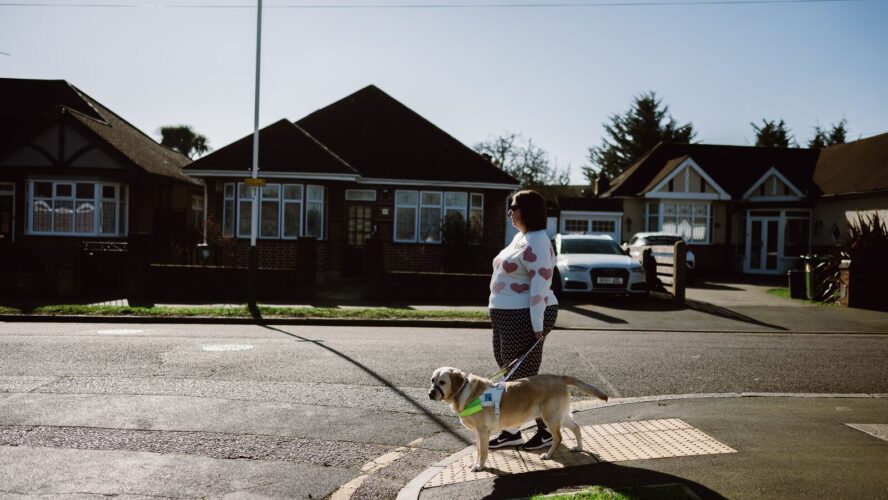 CAP client crossing the street with her guide dog