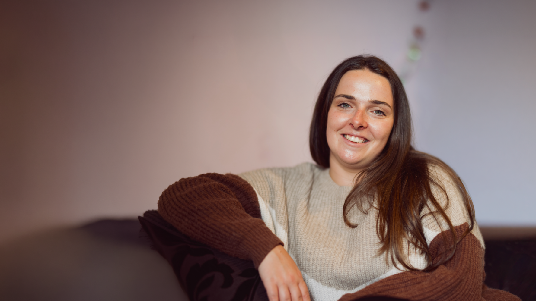 Jade, a young white lady with dark brown hair, smiling