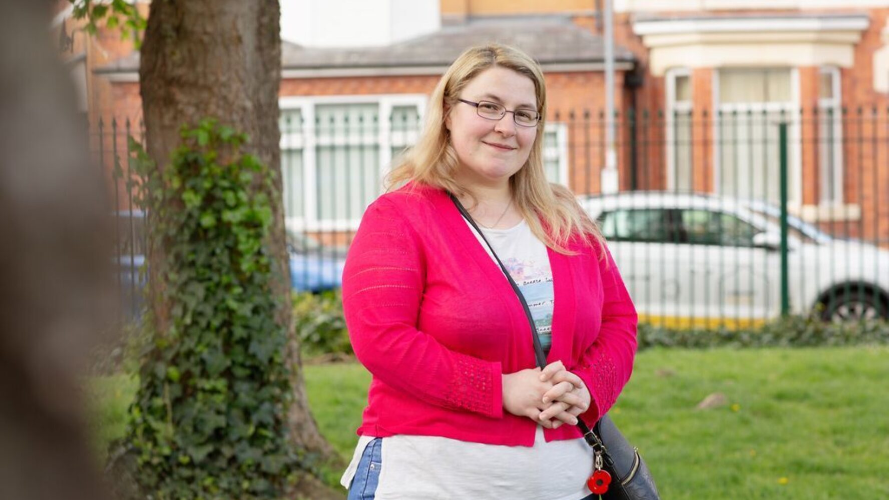 CAP client, now debt free, stood in her local park, smiling at the camera