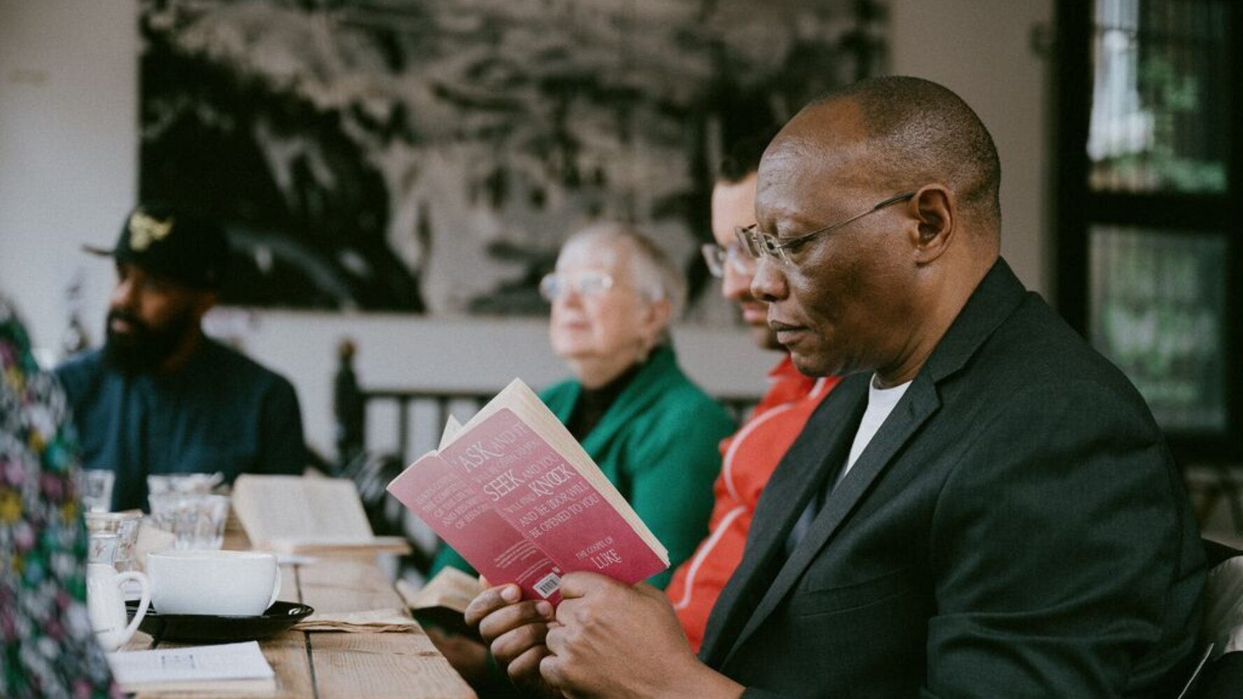 CAP client, Jim, at a local community centre, reading the gospel of Luke