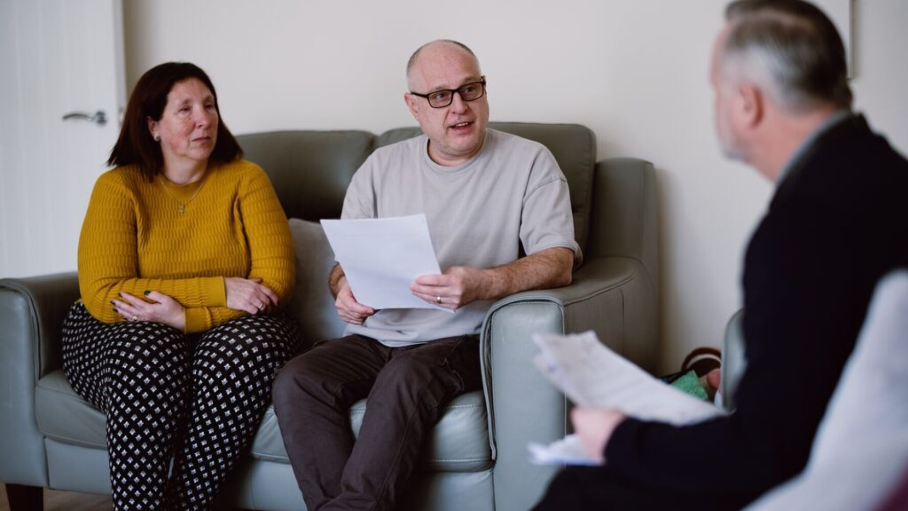 CAP client and her husband sat in their living room, speaking to their debt coach